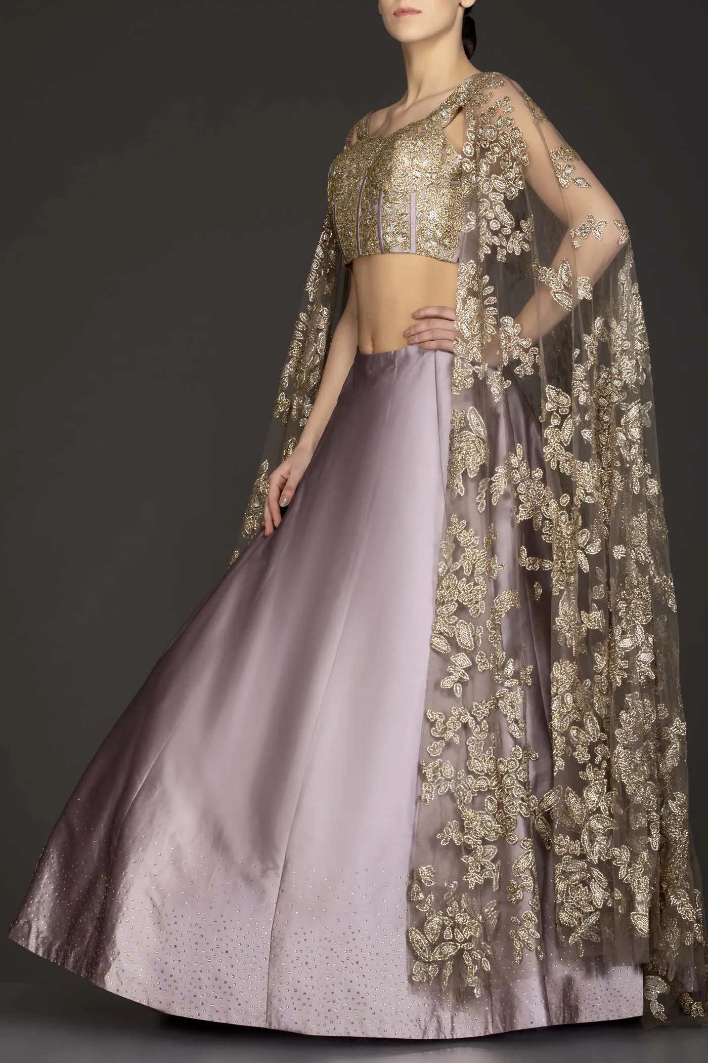 Mauve Colour Silk Skirt With Heavily Embriodered Net Top And Attached Net Cape